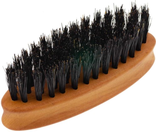 A wooden brush with black bristles, some with small yellow tips, on a white background.
