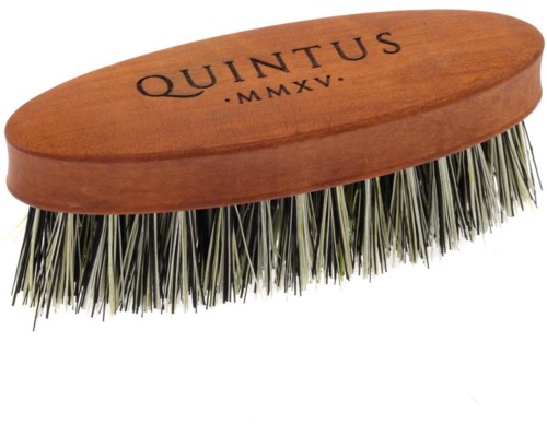 A wooden brush with metal bristles and the word QUINTUS written on it, along with Roman numerals.