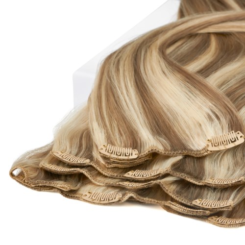 Hårförlängningar för styling, färg är blont, lockigt och flerdelat, placerade på en vit bakgrund.
