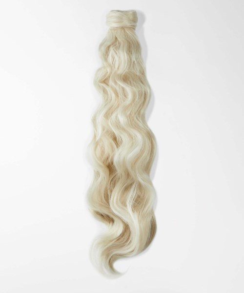 Blonde wavy hair extension or wig hanging against a white background.