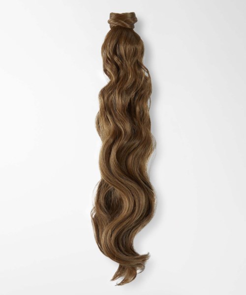 A long, wavy brown hair extension or wig hangs against a plain background.