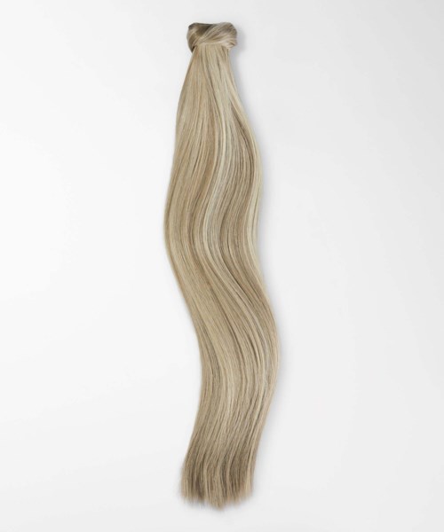 A long, straight, blond hair extension placed on a white background.