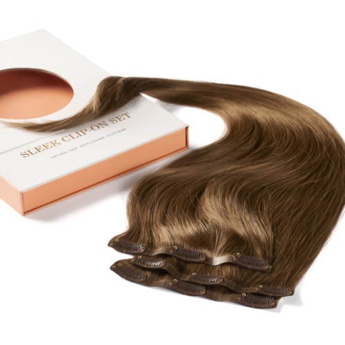 A hair extension clip-on set with brown hair, clips attached, and a box for packaging.
