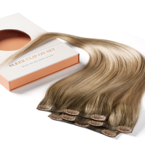 A box labeled "SLEEK CLIP ON SET" with hair extensions attached to clips.