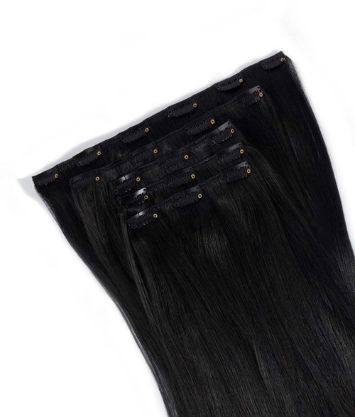 Black hair extensions with clips, long and straight, laid out on a white background.