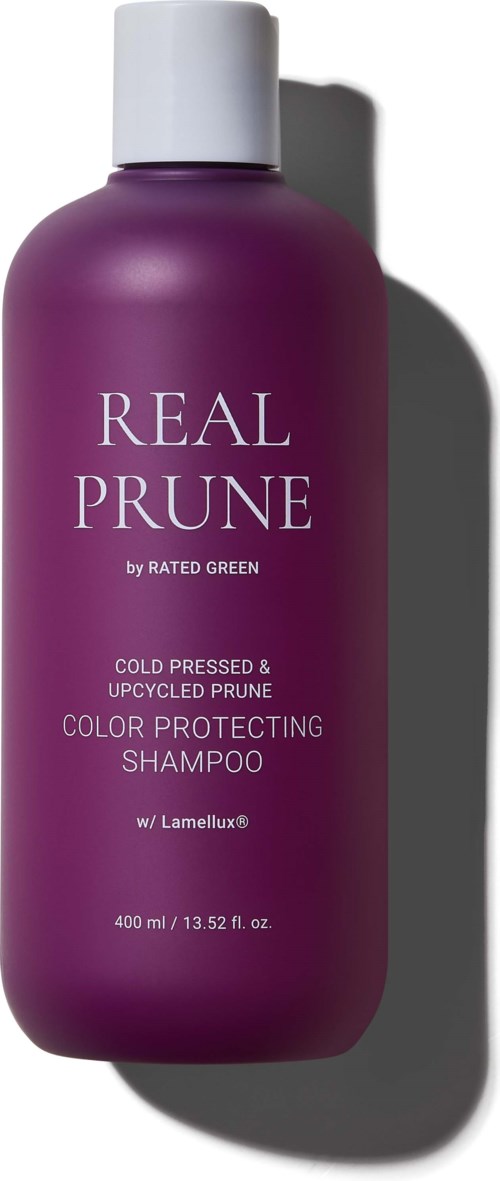 Lila shampoo fles met label Real Prune voor kleurenbescherming, met witte dop en schaduw.