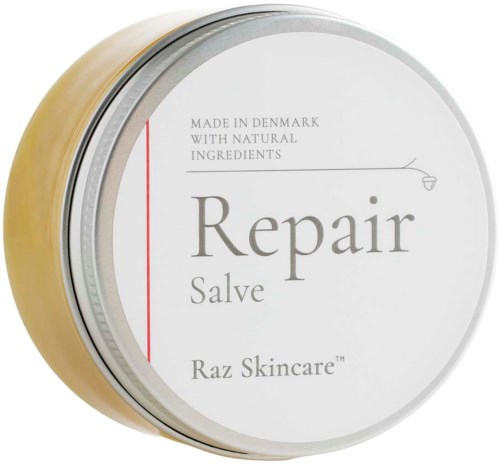 En rund burk med vit etikett, visar orden: 'Repair Salve', tillverkad i Danmark, med naturliga ingredienser.