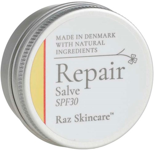 En vit burk med ett silverlockbär med reparationssalva för huden, märkt SPF30, tillverkad i Danmark med naturliga ingredienser.