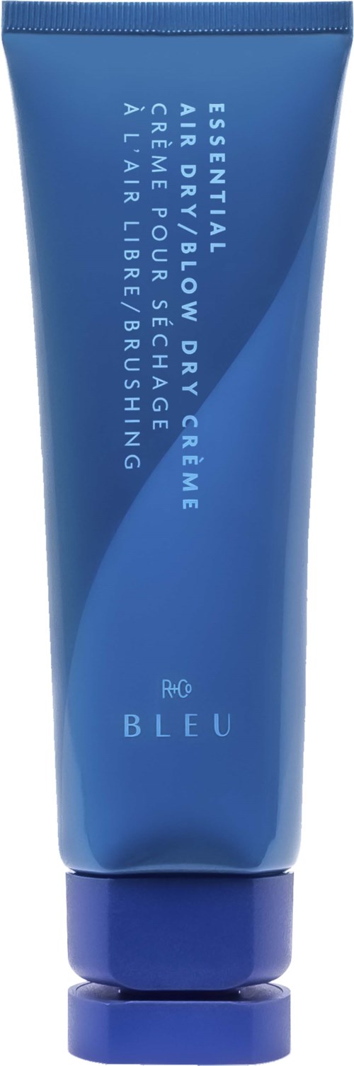 Blue tube with white text, labeled as a skincare product for dry skin, includes cleansing and scrubing. 