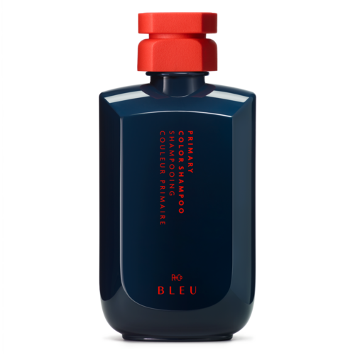 Eine dunkelblaue Flasche mit rotem Deckel und rotem Text, enthält Shampoo für glänzendes Haar.