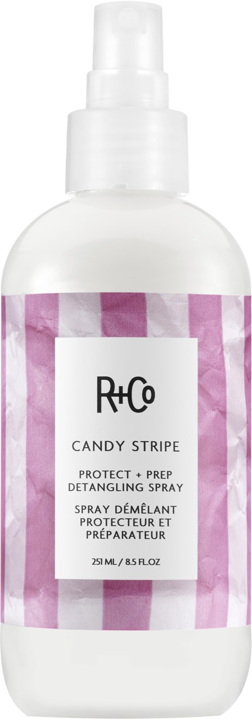 A white spray bottle with pink and white striped label, named R+Co Candy Stripe, for hair detangling.