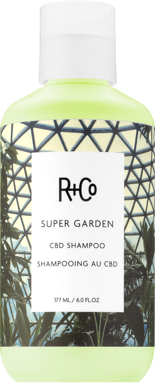 Groene shampoefles met plantenafbeeldingen en wit label met productdetails.