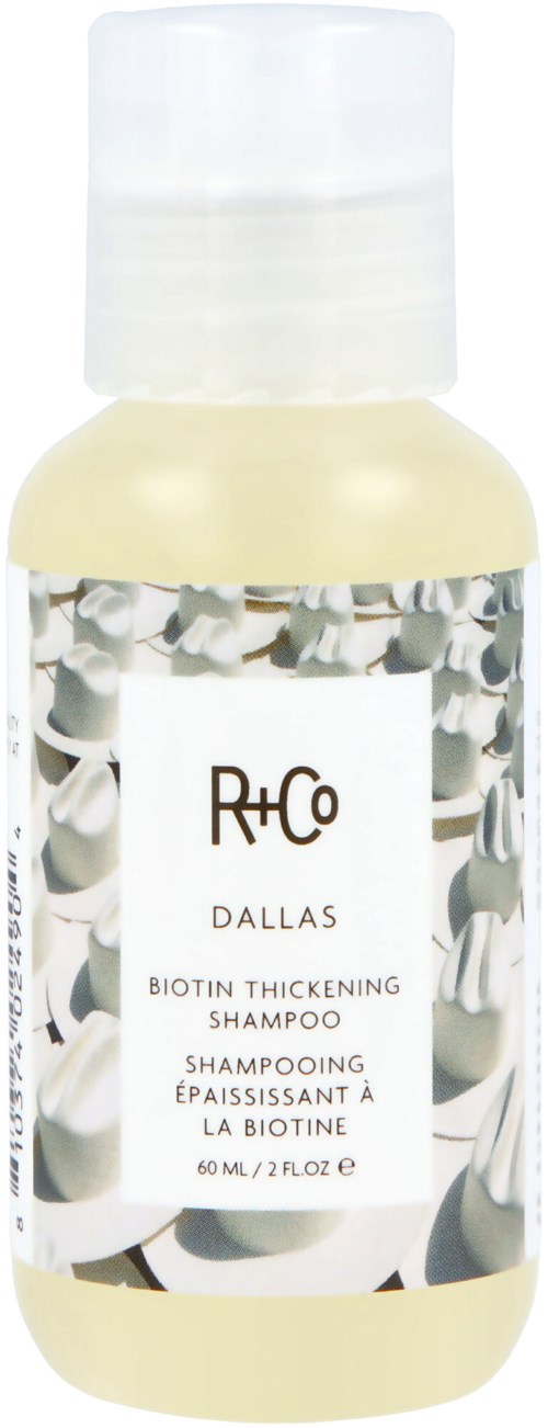 Kleine Flasche R+Co Dallas Biotin Verdickendes Shampoo mit weißem Deckel und Etikett mit weißen und schwarzen Mustern.
