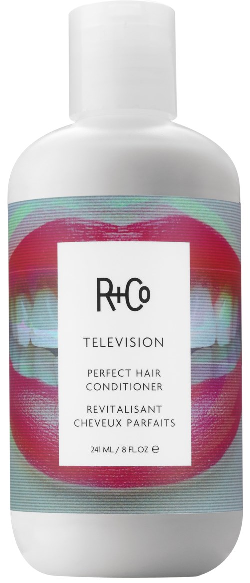 En hvit flaske med R+Co Television hårbalsam med en fargerik etikett som har abstrakte tenner.