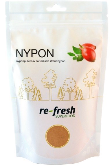 A white stand-up pouch with a red fruit illustration, trees, and text about Nypon, a superfood powder.