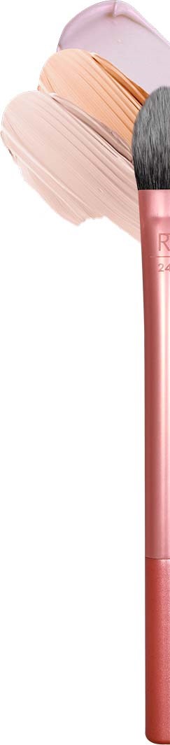 A makeup brush lies next to pink, beige, and white makeup smudges or swatches.