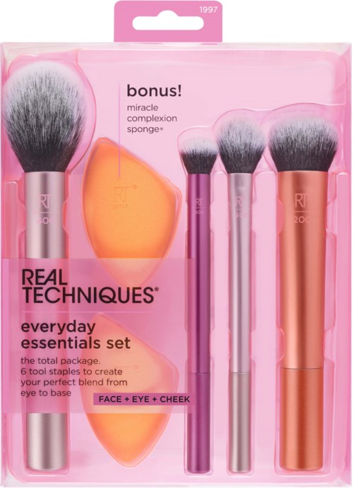 A set of six makeup brushes, a sponge, and two orange applicators in pink and rose-colored packaging.