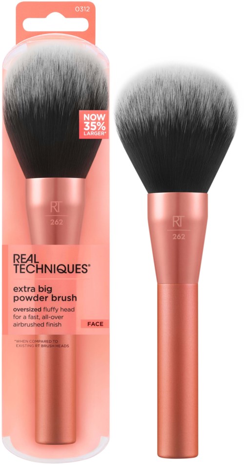 A large makeup brush with a rose gold handle and black, fluffy bristles, displayed both in packaging and outside.