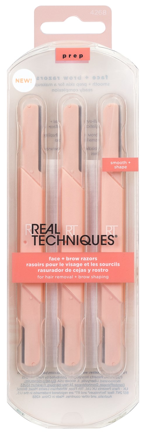 A set of three pink tweezers with white tips in a clear plastic package. The label reads "Real Techniques."