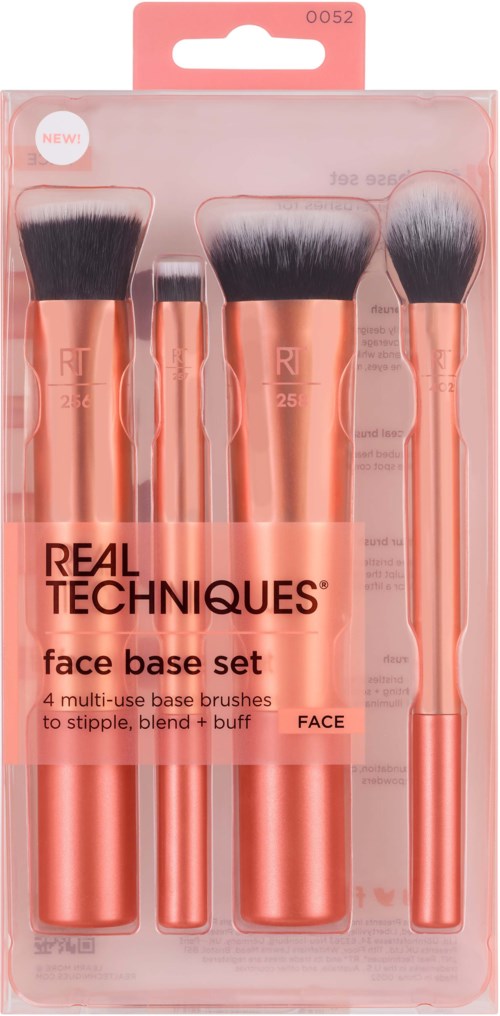 A set of four rose gold makeup brushes for face, in clear packaging with a pink label.