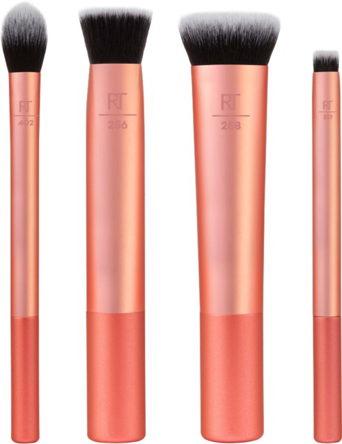 Four makeup brushes with pink handles and black bristles of different sizes lined up.