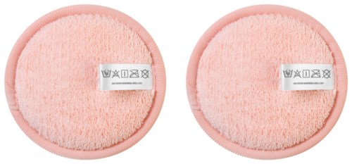 Two pink facial cleansing sponges with care instructions on labels. They are round and textured.