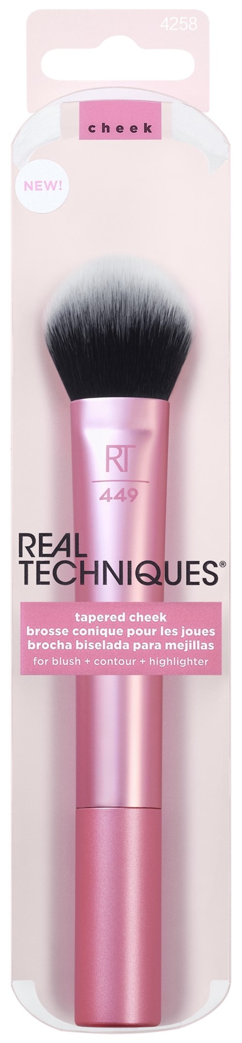 A pink makeup brush in packaging labeled 'Real Techniques' with a tapered brush head for cheeks.