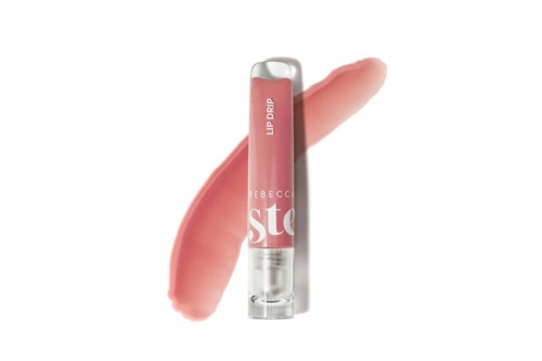 A lip gloss tube with a pink shade and a smear of lipstick color beside it.