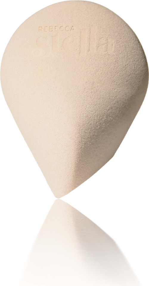 A beige beauty blender with embossed brand name and textured surface, shaped like an egg.