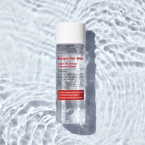 A clear bottle of cleansing water with a white cap, labeled "Recipe for men." It is placed on water with ripples.