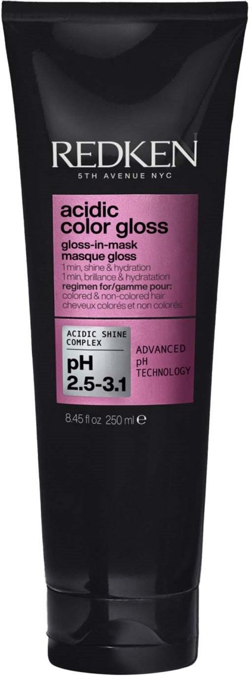 Een zwarte tube Redken zuurgraad glansmasker voor haar met roze label, vermeldt pH 2,5-3,1.