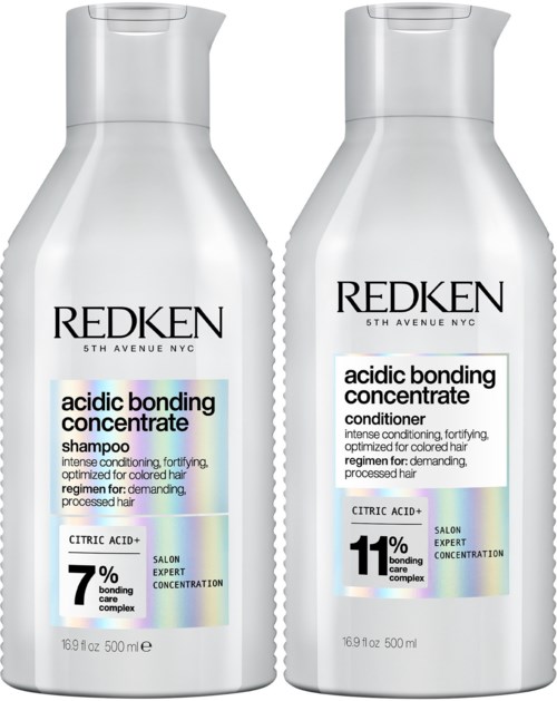Two bottles of Redken hair shampoo and conditioner, designed for colored hair, with label details and branding.