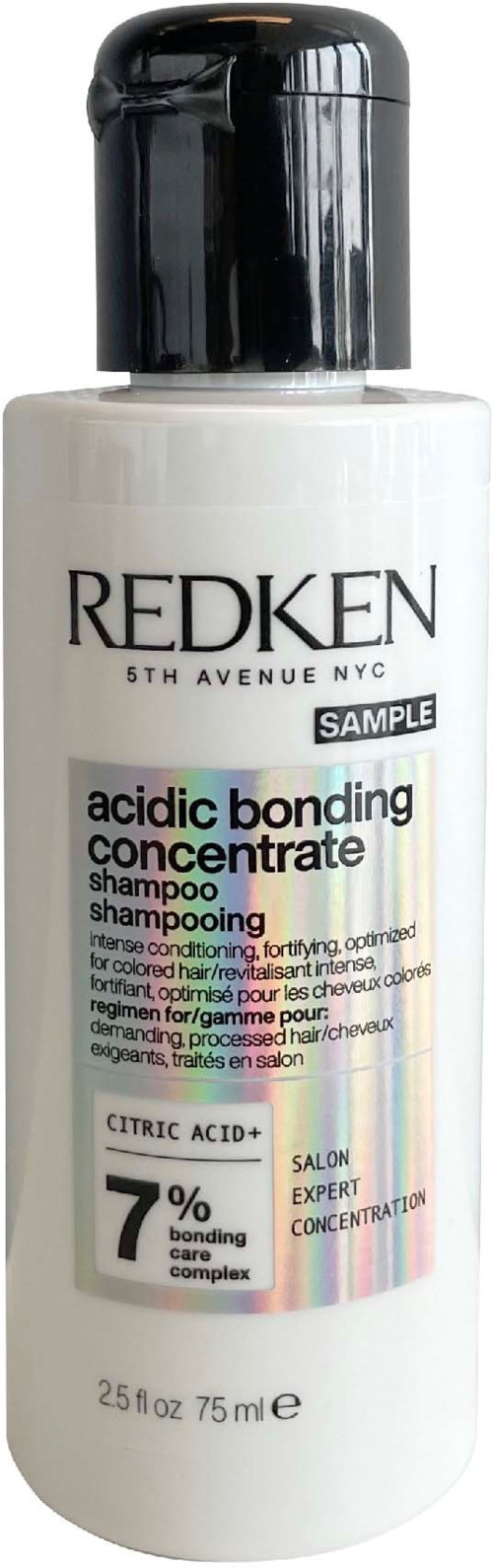 En vit flaska med Redken-schampo med svart lock, märkning som syra-bindningskoncentrat med citronsyra, 75 ml.