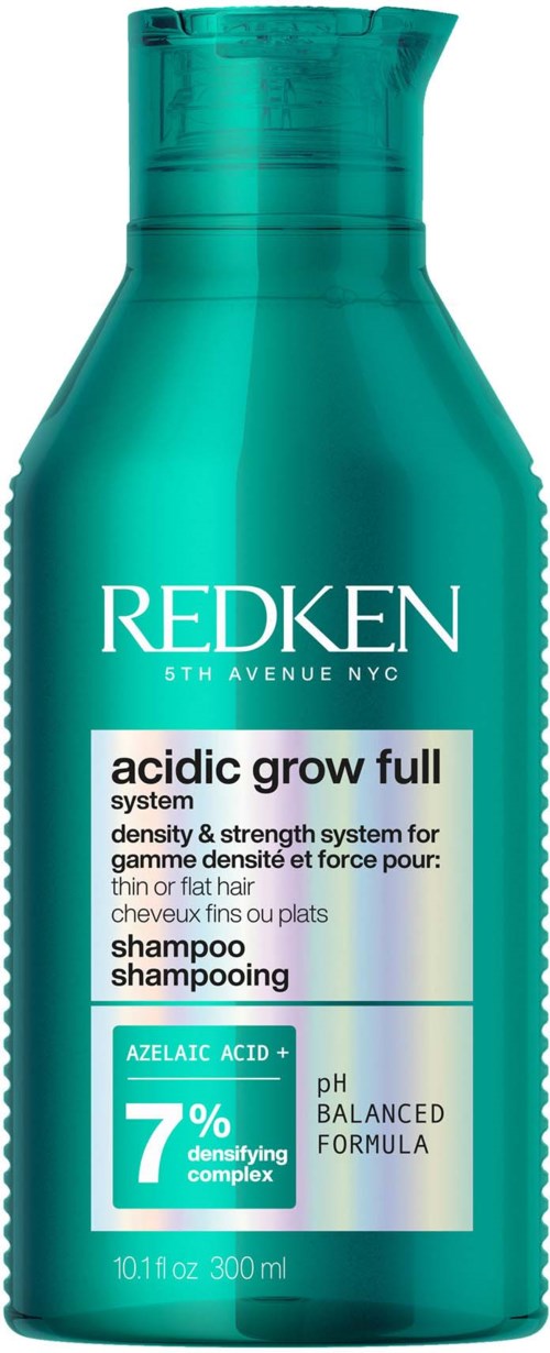 A teal bottle of Redken acid grow full shampoo with labels indicating pH balance and 7% ceramide complex.
