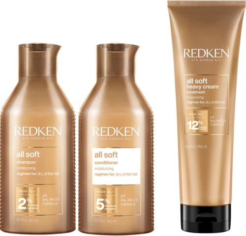 Drie haarverzorgingsproducten: shampoo, conditioner en zware crèmebehandeling, in gouden flessen voor droog, breekbaar haar.