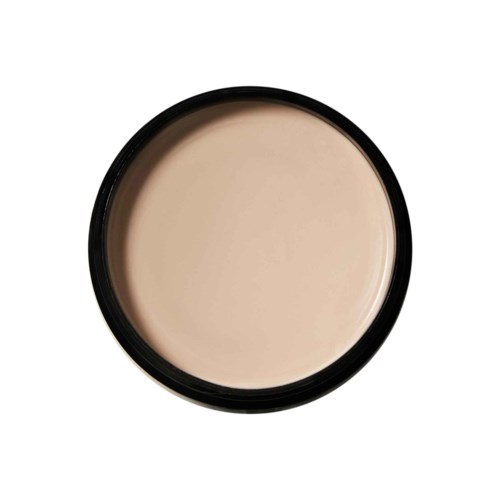 Een ronde container met beige substantie, mogelijk gezichtsprimer of foundation, binnenin. De container heeft een zwarte rand.