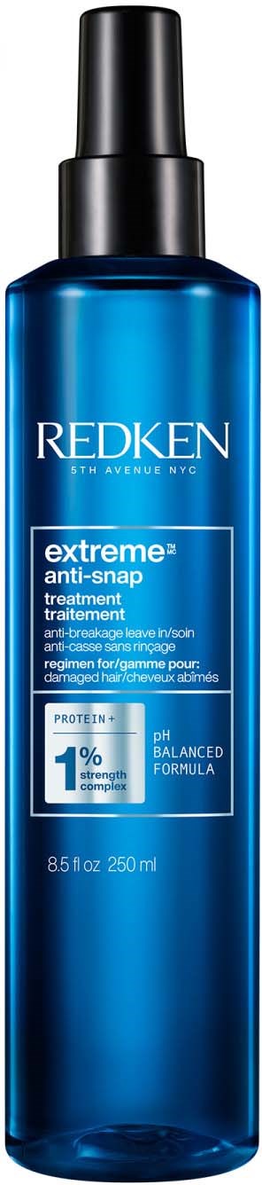Een blauwe fles Redken Extreme anti-snap behandeling met zwart spraydopje.