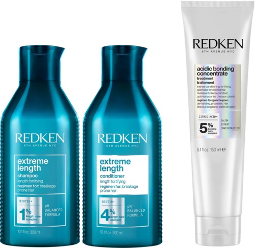 Drie haarverzorgingsproducten: shampoo, conditioner en behandeling, van Redken, voor beschadigd, breekbaar haar.