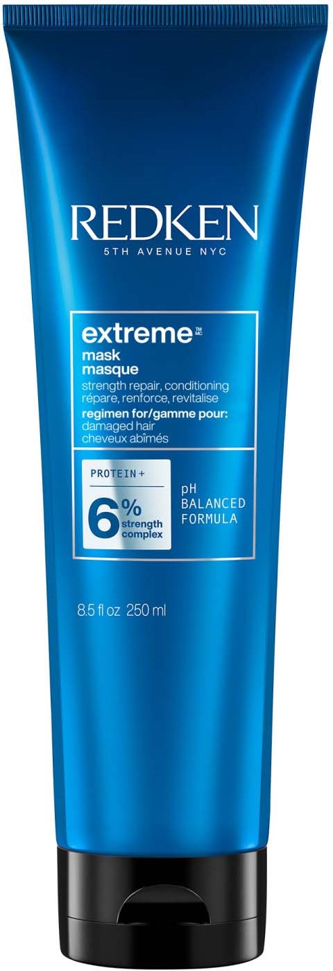 Een blauwe tube met Redken-shampoo of behandeling met productgegevens en merkaanduiding.