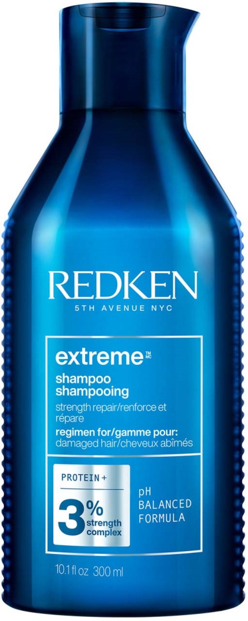 Blauwe fles Redken Extreme shampoo voor beschadigd haar, bevat 3% proteïne, pH gebalanceerd.
