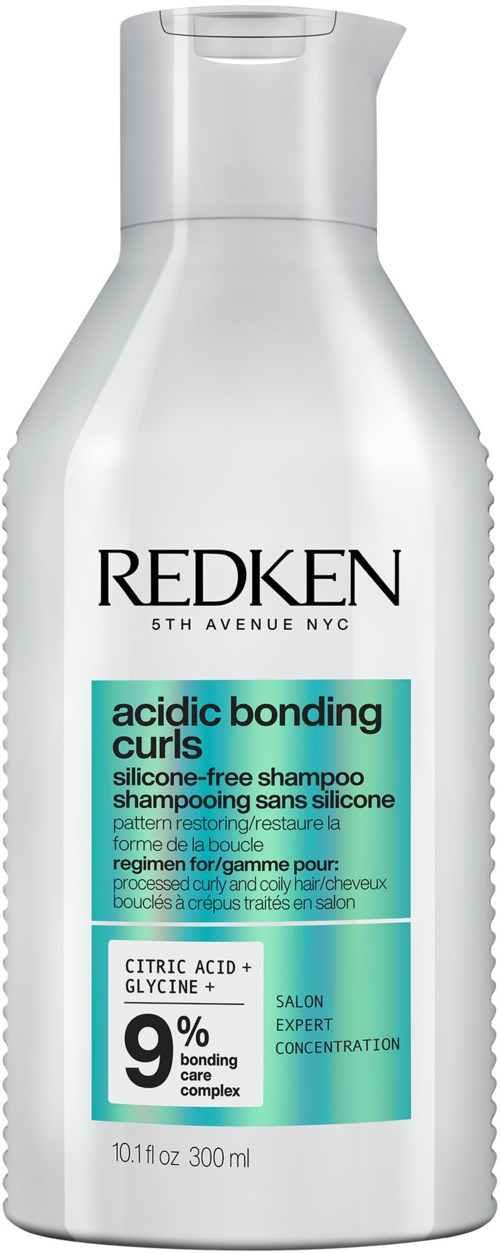 Een witte shampoo fles met 'Redken' en 'acidic bonding curls', 9% bonding complex, 300 ml.