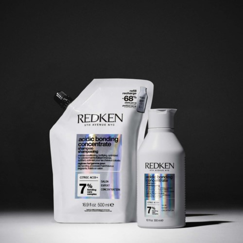 Two bottles of hair shampoo, one large refill pouch and one smaller bottle on a black background.