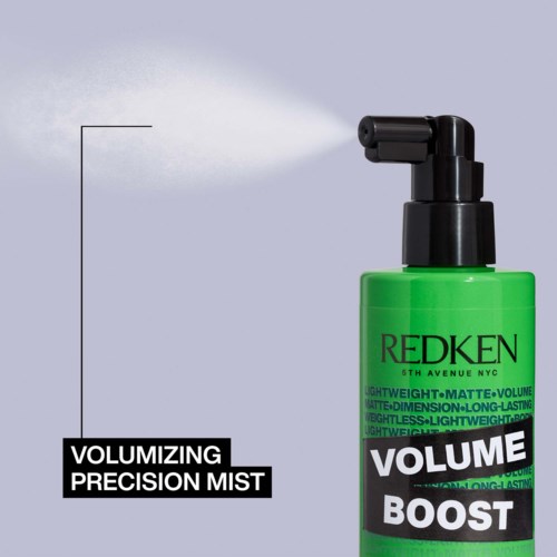 A green bottle labeled "VOLUME BOOST" releasing a mist. It is a volumizing precision mist for hair.