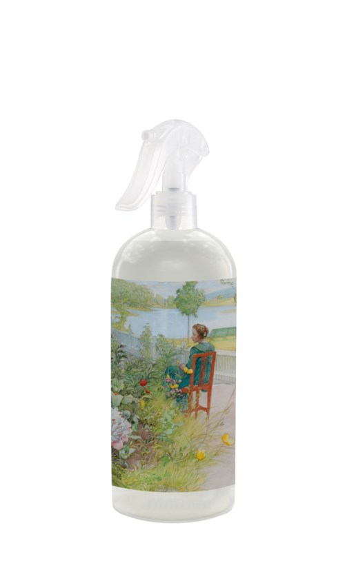 A spray bottle with a label showing a woman sitting outdoors by a river, surrounded by nature.