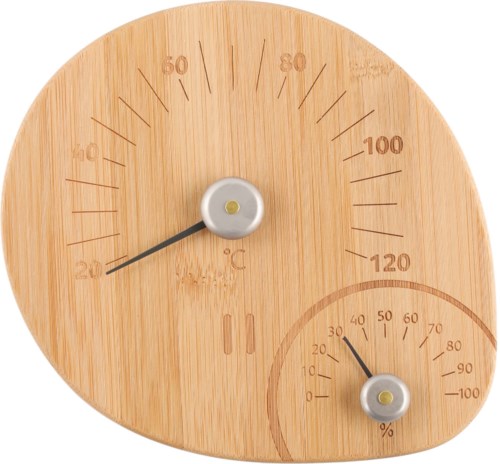 En trävänlig enhet visar temperatur i Celsius och luftfuktighet i procent med två vred, ett stort och ett litet.