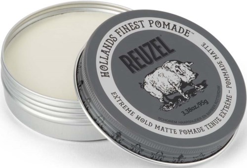 A round tin of Reuzel matte pomade with a bear logo on the lid, partly open showing white pomade.
