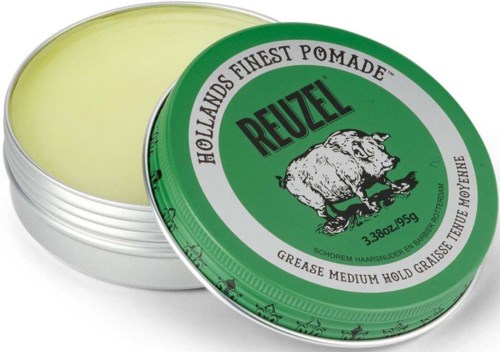 Green tin of hair pomade with a boar illustration and text about hold and quality.