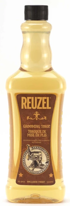 A bottle of Reuzel grooming tonic with a black cap, yellow liquid, and a brown label featuring gold and white details.