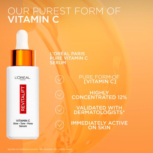 L'Oréal Paris Vitamin C serum bottle with orange and white label on a peach background.