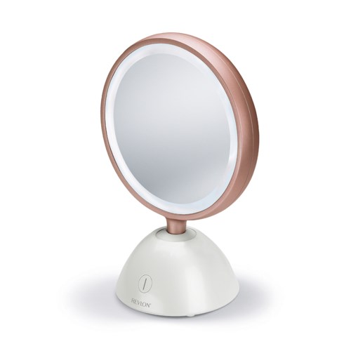 Een ronde make-up spiegel met een witte basis en een roségouden rand, staat op een vlakke ondergrond.